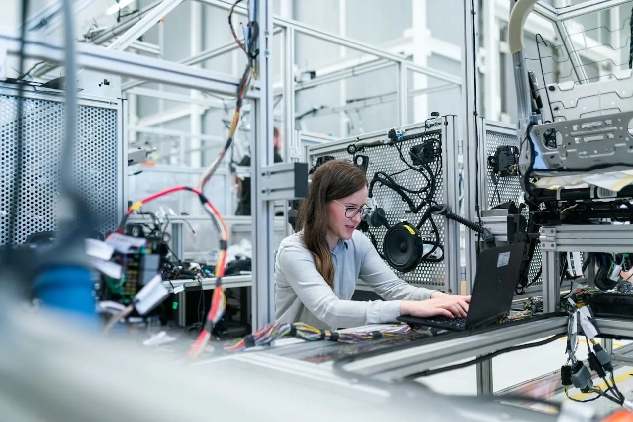 An engineer working with industrial robotics and automation equipment
