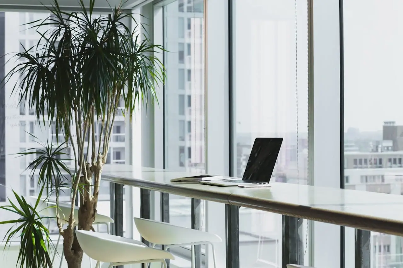 A technology team working together around a table of laptops